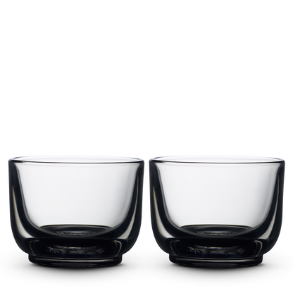 Two smoke Pirch Espresso Glasses by Fellow sit side by side on a plain white background.